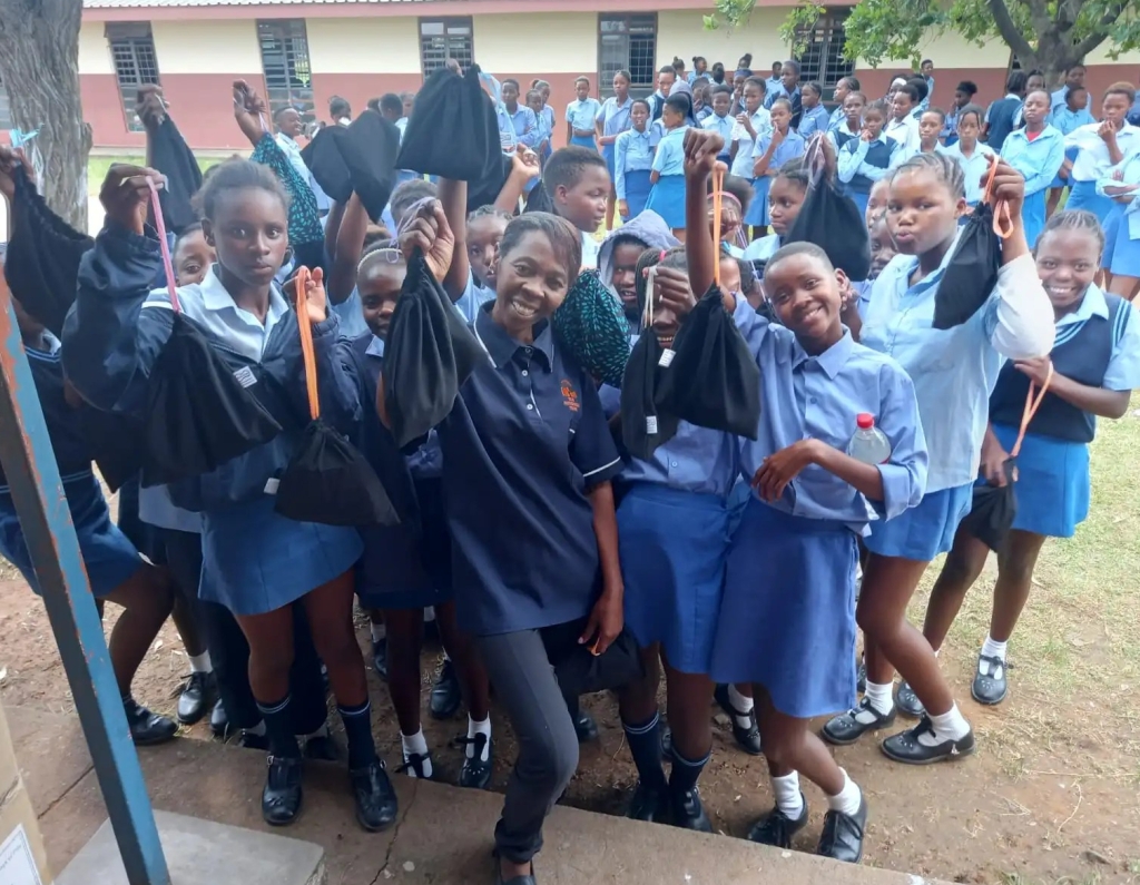Sister Grace distributing packs of Dignity Dreams eco-sanitary pads in secondary schools of the Waterberg
